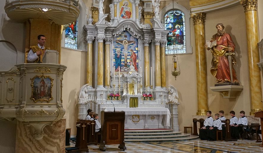 The Rev. John Ubel, pastor of the Church of Saint Agnes, preaches his homily about faithfulness to both tradition and the Vatican during one of the Catholic parish’s Latin Masses in St. Paul, Minn., Sunday, June 28, 2026. (AP Photo/Giovanna Dell’Orto)