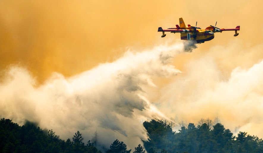 A plane drops a load of water on the Aspen Acres Fire near Colorado City, Colo., on Thursday, July 2, 2026. (Michael Seamans/The Gazette via AP)