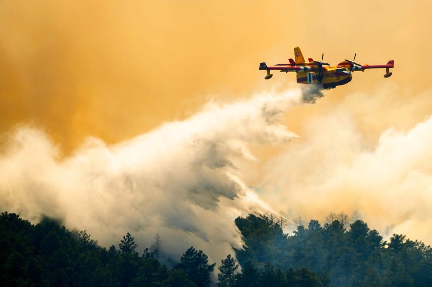A plane drops a load of water on the Aspen Acres Fire near Colorado City, Colo., on Thursday, July 2, 2026. (Michael Seamans/The Gazette via AP)