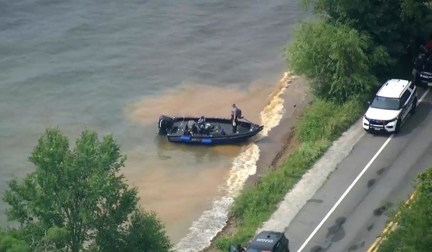 This image made from video provided by WISN-TV shows law enforcement use search boats in Geneva Lake, Wis., after receiving calls of an overturned boat on Friday, July 3, 2026. (WISN-TV via AP)