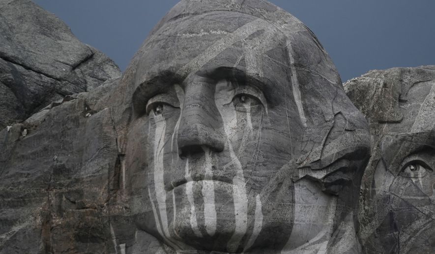 Rain runs down a sculpture of George Washington at Mount Rushmore National Memorial, Friday, July 3, 2026, in Keystone, S.D. (AP Photo/Matt Gade)