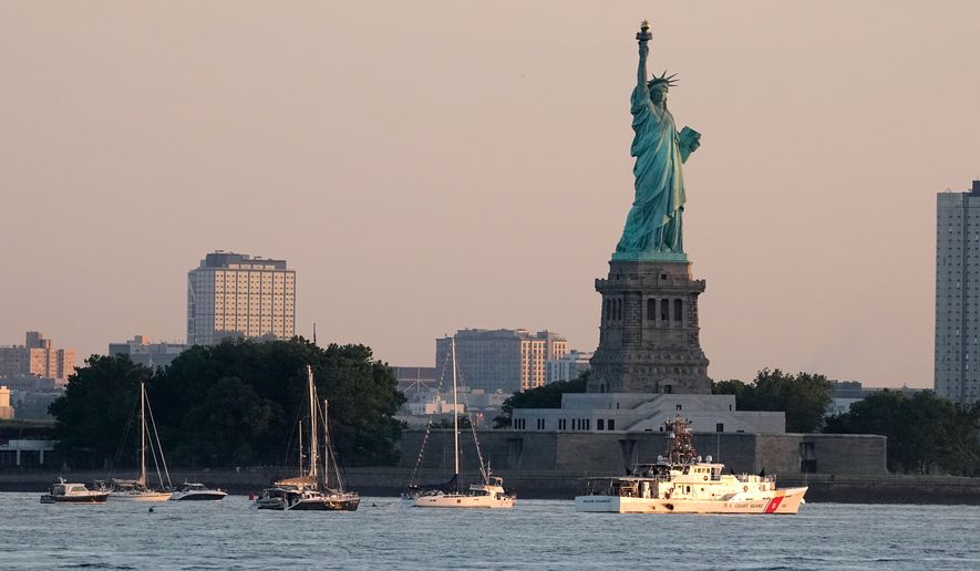A U.S. Coast Guard vessel sits with other pleasure craft below the Statue of Liberty in the New York harbor ahead of Sail250, a gathering of tall ships and military ships honoring America's 250th Anniversary, Saturday, July 4, 2026, in New York. (AP Photo/Frank Franklin II)