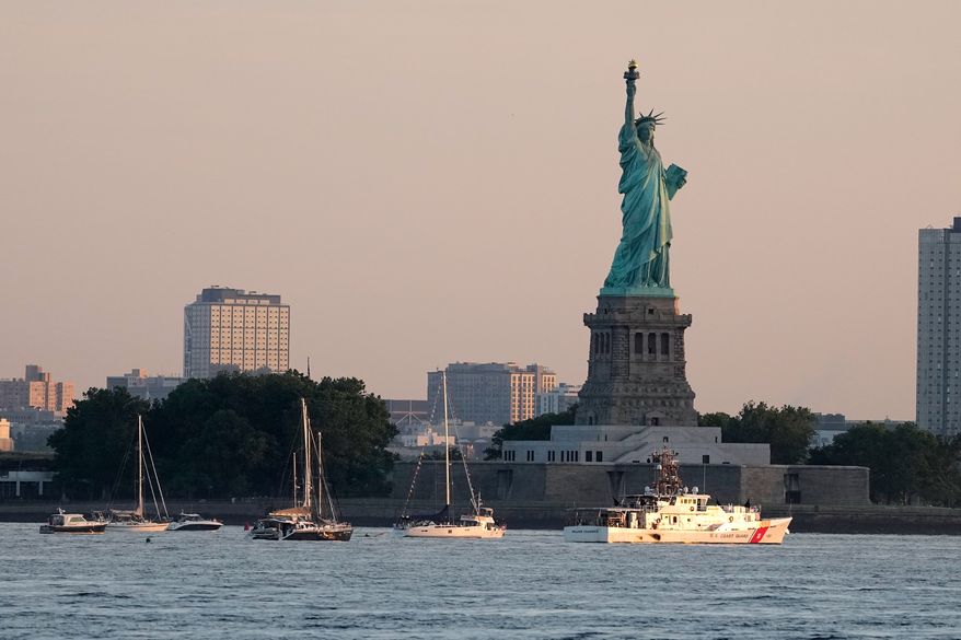 A U.S. Coast Guard vessel sits with other pleasure craft below the Statue of Liberty in the New York harbor ahead of Sail250, a gathering of tall ships and military ships honoring America's 250th Anniversary, Saturday, July 4, 2026, in New York. (AP Photo/Frank Franklin II)