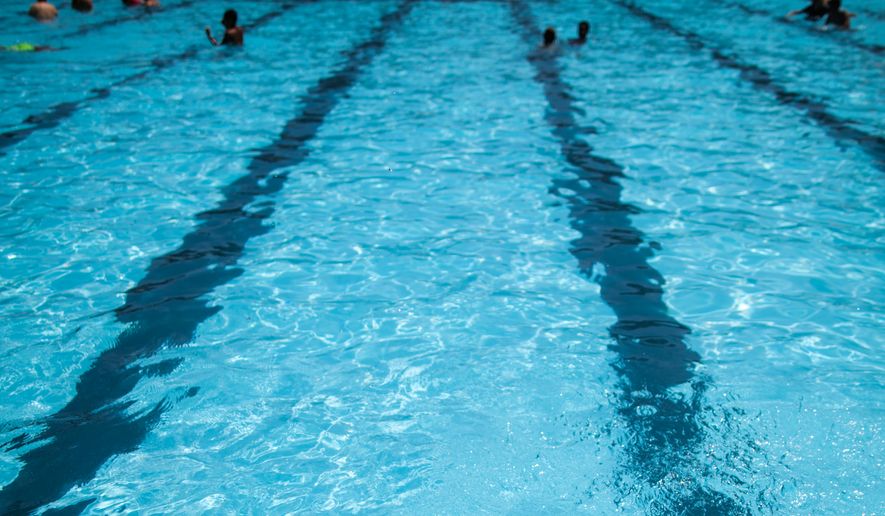 FILE - Children cool off at the Hamilton Fish pool, July 18, 2017, in the Lower East Side neighborhood of New York. (AP Photo/Mary Altaffer, File)