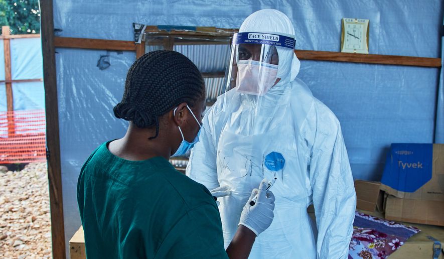 Health workers interact at the Evangelical Medical Center, in Bunia, eastern Congo, Friday, July 3, 2026, where Ebola clinical trials are scheduled to take place. (AP Photo/Dirole Lotsima Dieudonne)