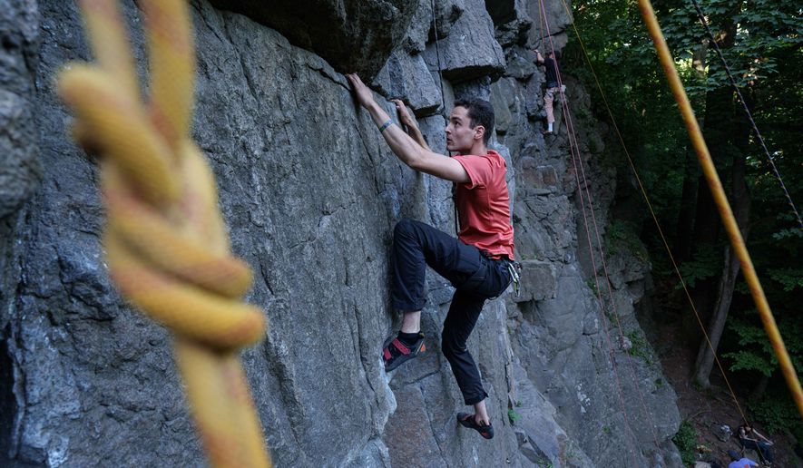 A man climbs on a cliff during the Stoned Climbers festival near Denyshi, Zhytomyr region, Ukraine, Saturday, June 27, 2026. (AP Photo/Evgeniy Maloletka)