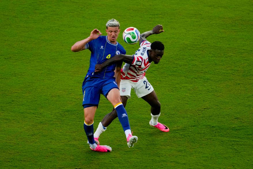 United States' Folarin Balogun (20) fouls Bosnia's Tarik Muharemovic (4) during the World Cup round of 32 soccer match between the United States and Bosnia in Santa Clara, Calif., near San Francisco, Wednesday, July 1, 2026. Balogun received a red card on the play. (AP Photo/Jeff Chiu)