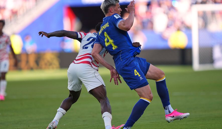 United States' Folarin Balogun (20) puts his foot down on Bosnia's Tarik Muharemovic (4) for which he received a red card during the World Cup round of 32 soccer match between the United States and Bosnia in Santa Clara, Calif., near San Francisco, Wednesday, July 1, 2026. (AP Photo/Martin Meissner)