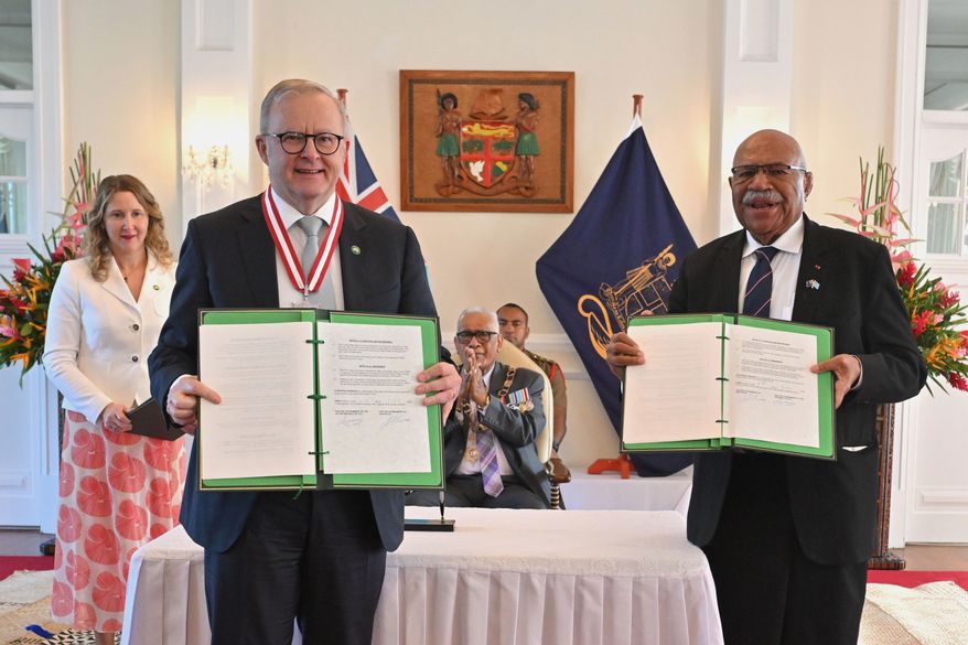 Australia's Prime Minister Anthony Albanese, left, and Fiji's Prime Minister Sitiveni Rabuka display a new bilateral defense alliance they have just signed at State House in Suva, Fiji, Monday, July 6, 2026. (Mick Tsikas/AAP Image via AP)