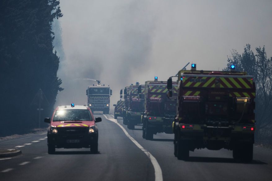 Firefighters work on a wildfire in Ille-sur-Têt, southern France, Monday, July 6, 2026. (AP Photo/Thibault Camus)