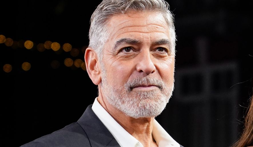 FILE - George Clooney appears at the screening of the film "The Boys In The Boat" in London on Dec. 3, 2023. (Photo by Alberto Pezzali/Invision/AP, File)