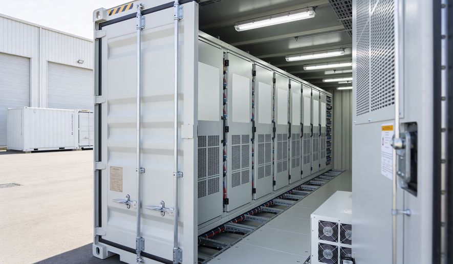 A portable data center solution featuring rows of server racks and integrated cooling units within a modified shipping container, ready for deployment. File photo credit: Snide12 via Shutterstock.
