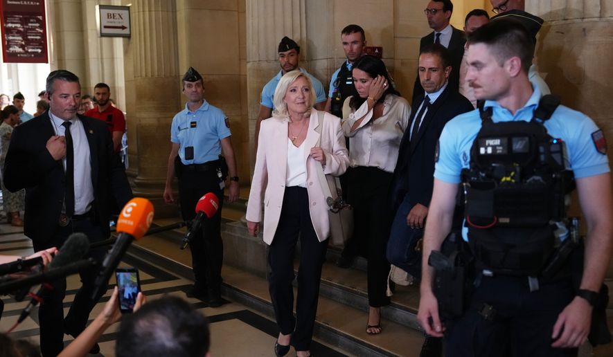 Far-right leader Marine Le Pen leaves the courtroom after the verdict of her appeal trial, in Paris, France, Tuesday, July. 7, 2026. (AP Photo/Aurelien Morissard)