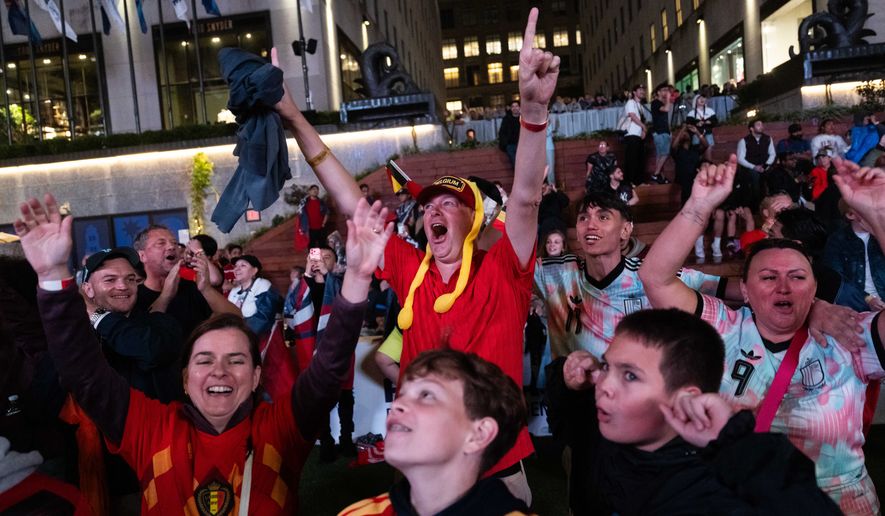 Belgium fans react after the team scored during the World Cup round of 16 soccer match between the United States and Belgium, at a watch party at the Rockefeller Center fan village, Monday, July 6, 2026, in New York. (AP Photo/Adam Gray)