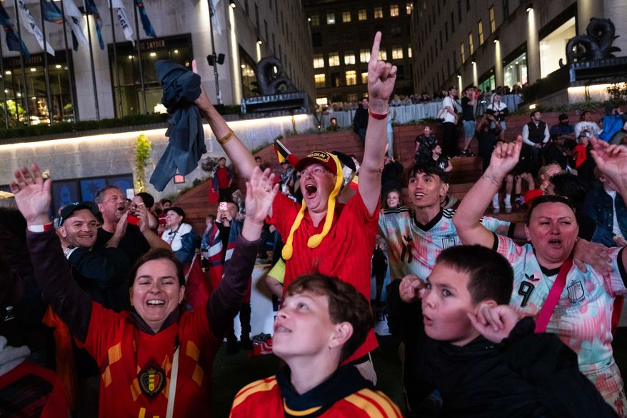 Belgium fans react after the team scored during the World Cup round of 16 soccer match between the United States and Belgium, at a watch party at the Rockefeller Center fan village, Monday, July 6, 2026, in New York. (AP Photo/Adam Gray)