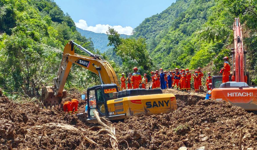 In this photo released by Xinhua News Agency, rescuers conduct search and rescue at the site of a landslide at a village in Nanhe township of Tanchang County, Longnan City, northwest China's Gansu Province on Tuesday, July 7, 2026. (Xinhua via AP)