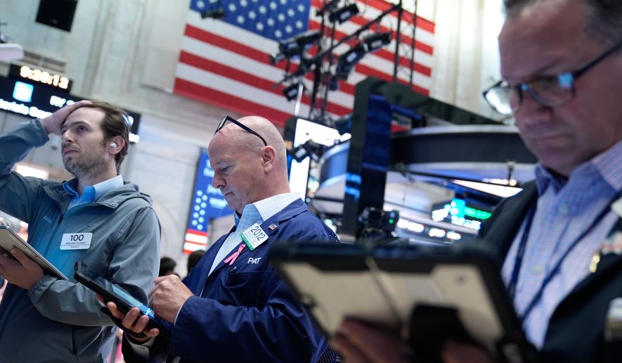 Traders work on the floor at the New York Stock Exchange in New York, Monday, July 6, 2026. (AP Photo/Seth Wenig)