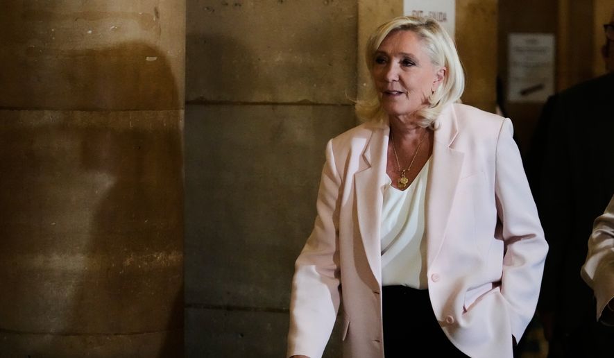 Marine Le Pen arrives at the courtroom for the verdict of her appeals trial, in Paris, France, Tuesday, July. 7, 2026. (AP Photo/Michel Euler)