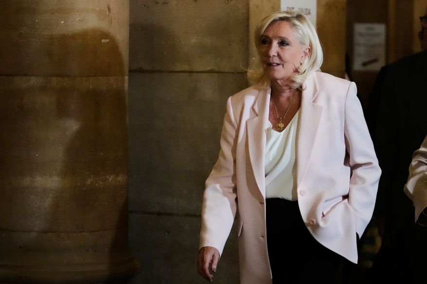 Marine Le Pen arrives at the courtroom for the verdict of her appeals trial, in Paris, France, Tuesday, July. 7, 2026. (AP Photo/Michel Euler)