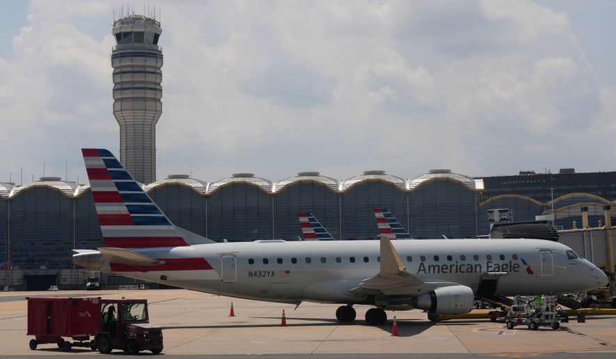 FILE - An American Eagle plane is parked at a gate at the Ronald Reagan Washington National Airport in Arlington, Va., June 29, 2026. (AP Photo/Carolyn Kaster, File)