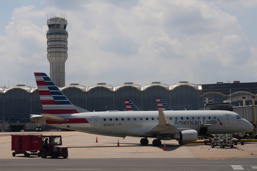 FILE - An American Eagle plane is parked at a gate at the Ronald Reagan Washington National Airport in Arlington, Va., June 29, 2026. (AP Photo/Carolyn Kaster, File)