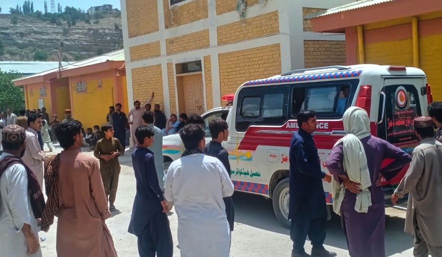 People watches an ambulance arrive with the bodies of police officers who were killed in an militants overnight attack, at a hospital in Ziarat, a district in Pakistan's southwetern Balochistan province, Tuesday, July 7, 2026. (AP Photo)