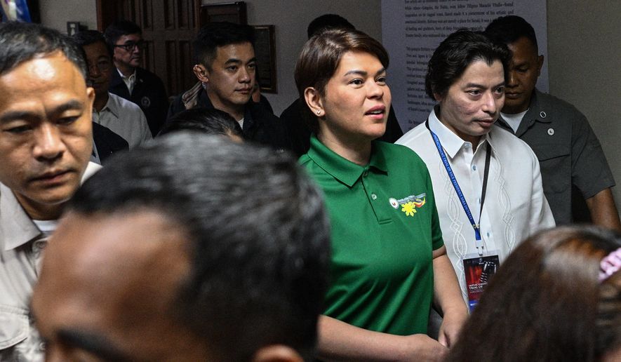 Philippine Vice President Sara Duterte, center, arrives before the start of the impeachment trial at the Senate of the Philippines in Pasay, Philippines Tuesday, July 7, 2026. (Noel Celis/Pool Photo via AP)