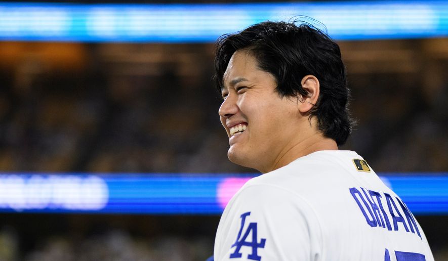 Los Angeles Dodgers' Shohei Ohtani smiles during the eleventh inning of a baseball game against the Colorado Rockies in Los Angeles, Monday, July 6, 2026. (AP Photo/Kyusung Gong)