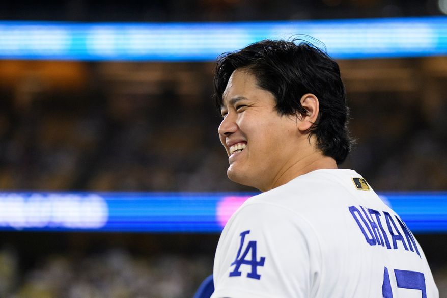 Los Angeles Dodgers' Shohei Ohtani smiles during the eleventh inning of a baseball game against the Colorado Rockies in Los Angeles, Monday, July 6, 2026. (AP Photo/Kyusung Gong)