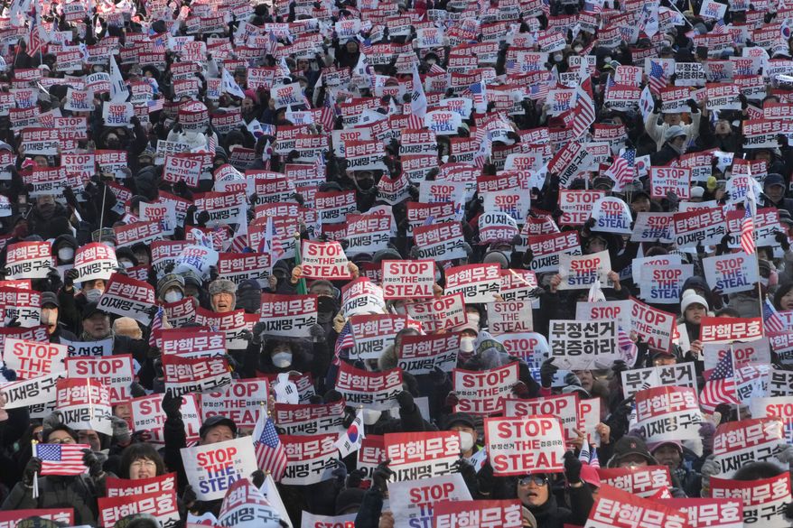 FILE- Supporters of impeached South Korean President Yoon Suk Yeol stage a rally to oppose his impeachment in Seoul, South Korea, Jan. 11, 2025. The letters read, "Impeachment is invalid." (AP Photo/Ahn Young-joon, File)