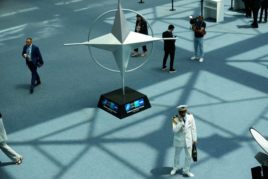 Participants walk near displays during the NATO Defense Industry Forum at the NATO summit in Ankara, Turkey, Tuesday, July 7, 2026. (AP Photo/Hussein Malla)