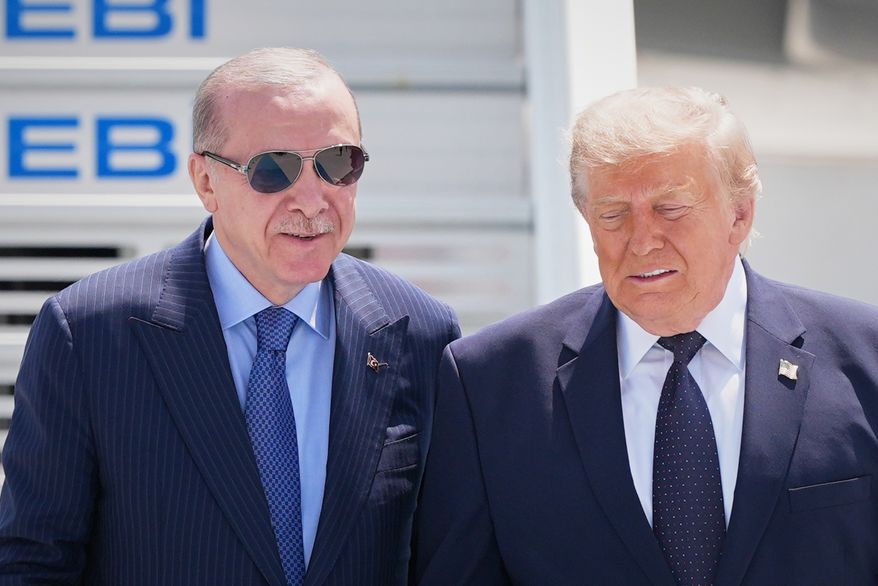 President Donald Trump walks with Turkish President Recep Tayyip Erdogan, left, upon arriving for the NATO summit in Ankara, Turkey, Tuesday, July 7, 2026. (AP Photo/Alex Brandon)
