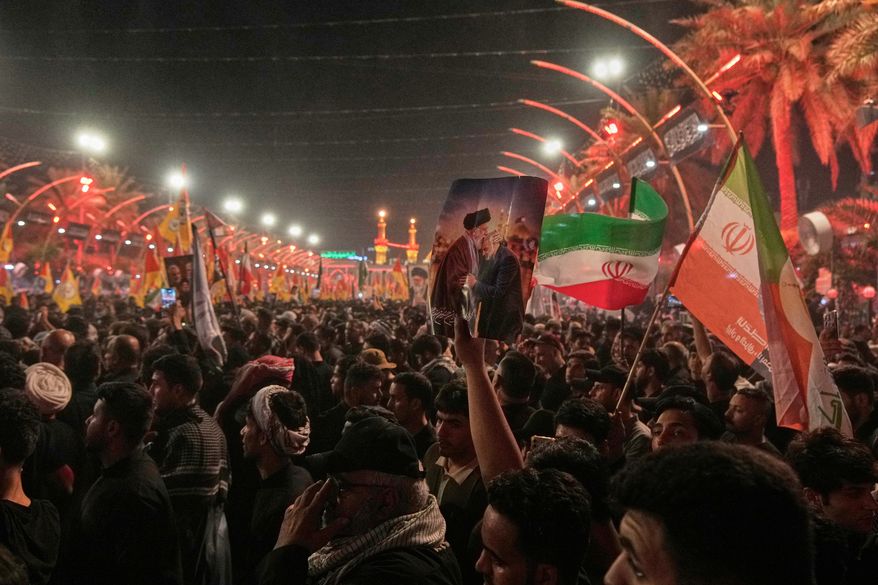 Mourners wait for the arrival of the funeral procession of the late Iranian Supreme Leader Ayatollah Ali Khamenei outside the Imam Hussein Shrine in Karbala, Iraq, Wednesday, July 8, 2026. (AP Photo/Khalil Hamra)