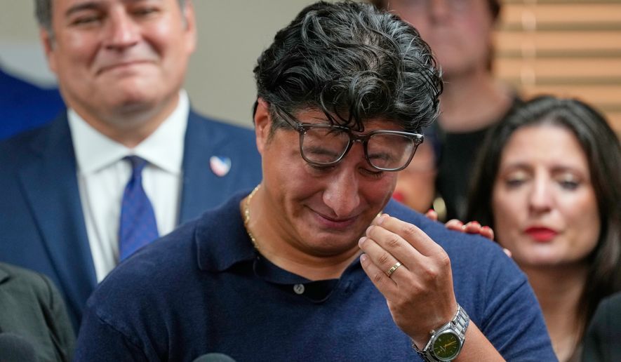 Ronaldo Salgado, son of Lorenzo Salgado Araujo, wipes away tears while speaking during a news conference Wednesday, July 8, 2026, in Houston. (AP Photo/David J. Phillip)
