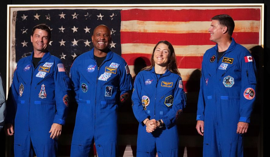 Artemis II crew members Reid Wiseman, from left, Victor Glover, Christina Koch and Jeremy Hansen stand as President Donald Trump speaks during Salute to America, an Independence Day event honoring the nation's 250th anniversary, Saturday, July 4, 2026, on the National Mall in Washington. (AP Photo/Mark Schiefelbein)