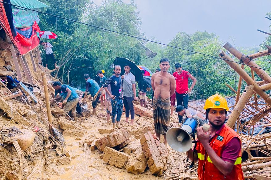 Rescuers work at the site of a landslide at a Rohingya refugee camp in Cox's Bazar, Bangladesh, Wednesday, July 8, 2026. (AP Photo/Shamimul Islam Faisal)