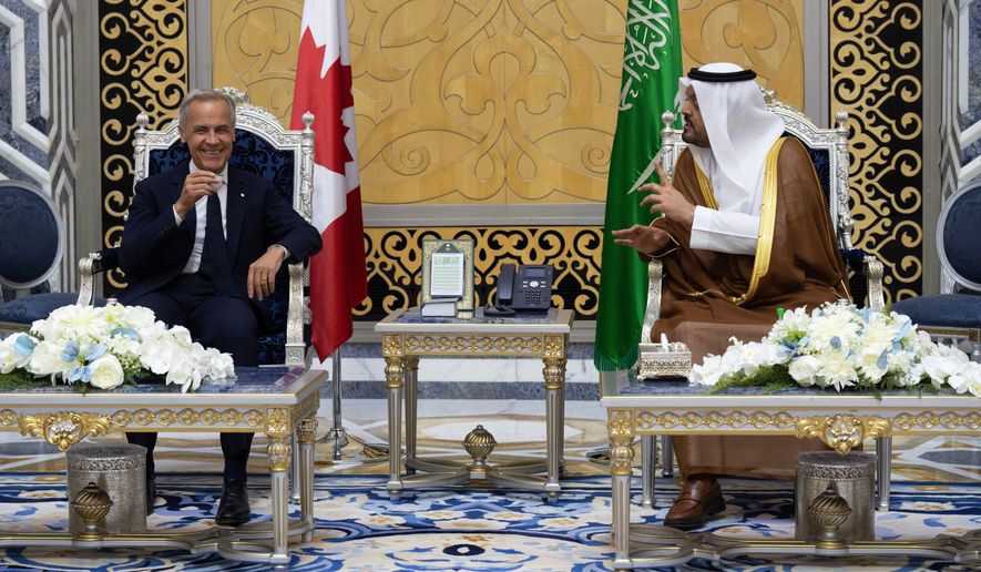 Canada Prime Minister Mark Carney participates in a welcome ceremony with Prince Saud bin Mishaal bin Abdulaziz Al Saud after arriving In Jeddah, Saudi Arabia, Wednesday, July 8, 2026. (Adrian Wyld/The Canadian Press via AP)
