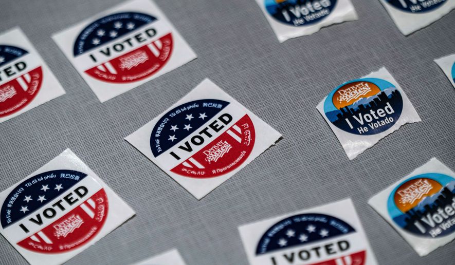 "I voted" stickers sit near a ballot box during the Democratic primaries at Denver Public Library Tuesday, June 30, 2026, in Denver. (AP Photo/Rebecca Slezak)