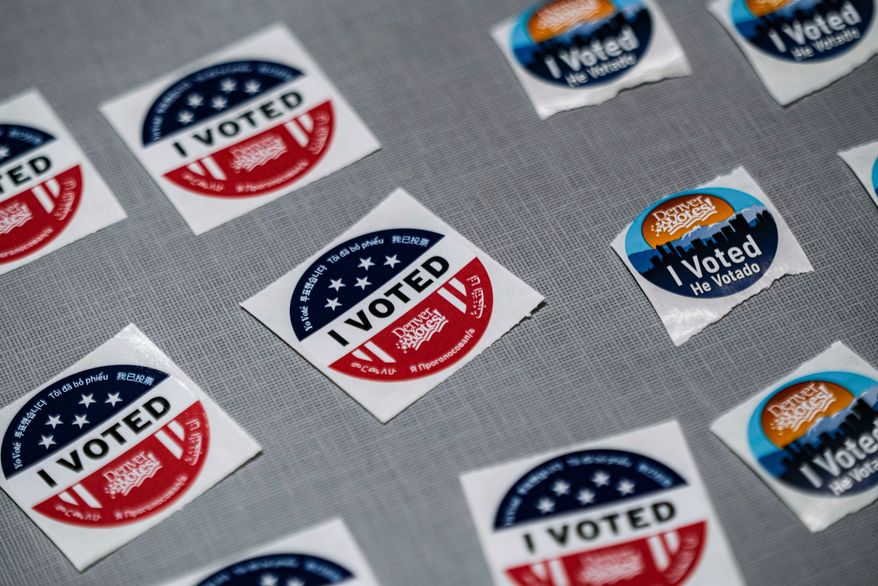 "I voted" stickers sit near a ballot box during the Democratic primaries at Denver Public Library Tuesday, June 30, 2026, in Denver. (AP Photo/Rebecca Slezak)