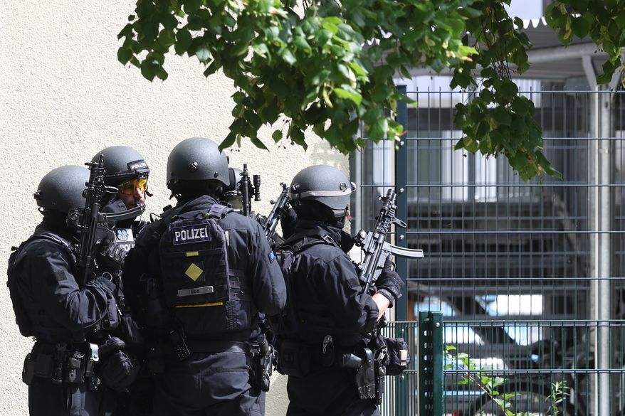 Heavily armed police officers guard at the Welfen High School, Schongau, Germany, Wednesday, July 8, 2026. (Karl-Josef Hildenbrand/dpa via AP)