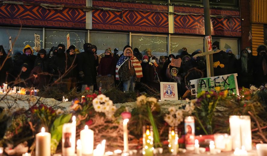 FILE - People gather during a vigil for 37-year-old Alex Pretti, who was fatally shot by a U.S. Border Patrol officer earlier in the day, Jan. 24, 2026, in Minneapolis. (AP Photo/Adam Gray, File)