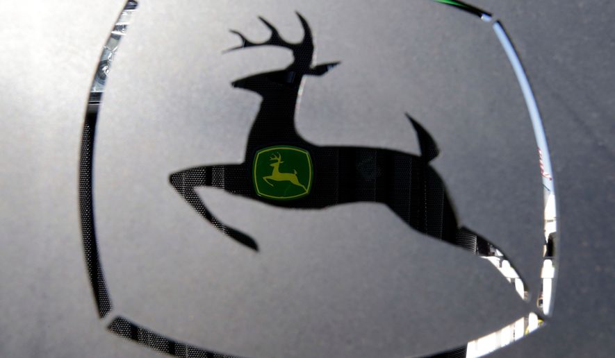 FILE - A John Deer emblem is seen at the Husker Harvest Days farm show in Wood River, Neb., Sept. 12, 2018. (AP Photo/Nati Harnik, File)
