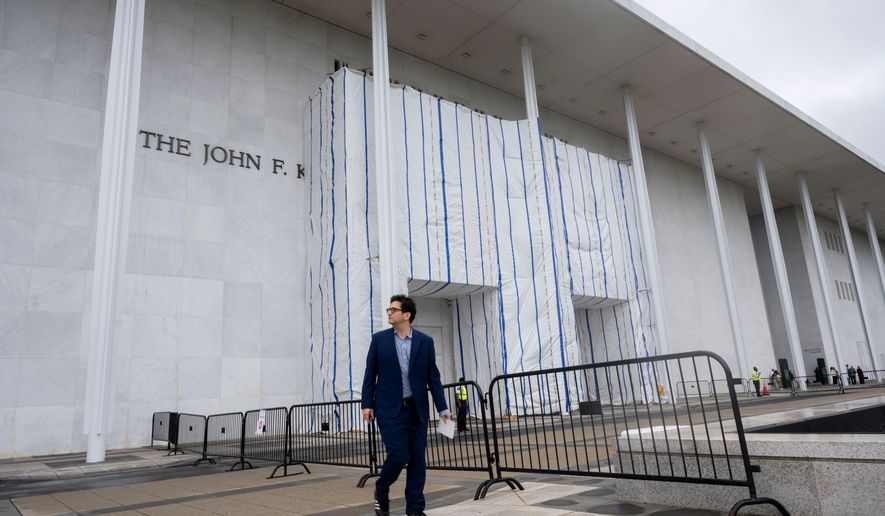 People walk near the tarp covered front entrance of the Kennedy Center for the Performing Arts before the start of the 27th Annual Mark Twain Prize for American Humor Celebrating Bill Maher, Sunday, June 29, 2026, in Washington. (AP Photo/Kevin Wolf)