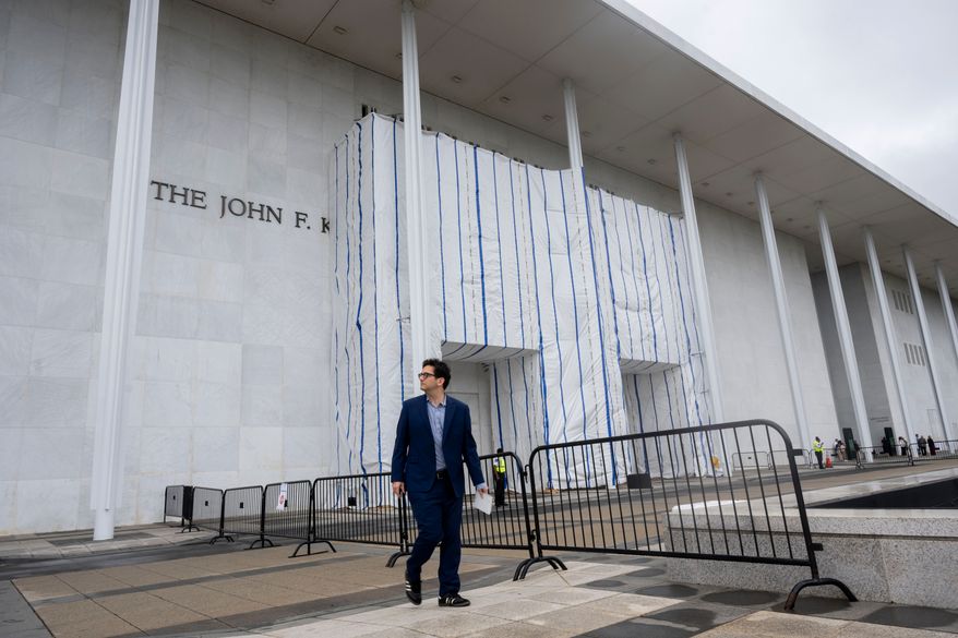 People walk near the tarp covered front entrance of the Kennedy Center for the Performing Arts before the start of the 27th Annual Mark Twain Prize for American Humor Celebrating Bill Maher, Sunday, June 29, 2026, in Washington. (AP Photo/Kevin Wolf)