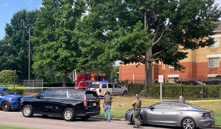 Law enforcement officers work the scene after a federal agent with the Memphis Safe Task Force shot and killed a person at a hotel in Memphis, Tenn., on Wednesday, July 8, 2026. (Natalie Van Gundy/Daily Memphian via AP)