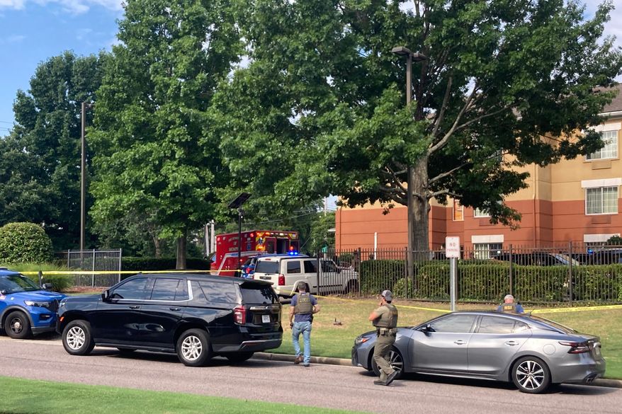 Law enforcement officers work the scene after a federal agent with the Memphis Safe Task Force shot and killed a person at a hotel in Memphis, Tenn., on Wednesday, July 8, 2026. (Natalie Van Gundy/Daily Memphian via AP)