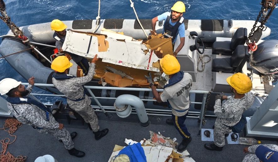 In this photo released by Pakistan Navy, Pakistan Navy personnel shift the wreckage of a cargo plane of the private carrier K2 Airways into a naval ship after recovering them from deep sea near Omara, a town some 360 kms. (220 miles) west of Karachi, Pakistan, Wednesday, July 8, 2026. (Pakistan Navy via AP)