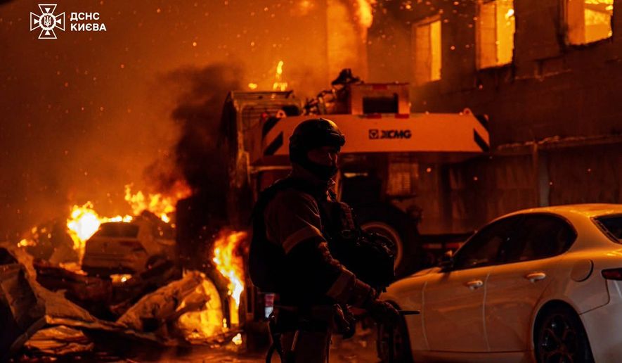 In this photo provided by the Ukrainian Emergency Service, emergency services personnel work to extinguish a fire following a Russian air attack in Kyiv, Ukraine, Wednesday, July 8, 2026. (Ukrainian Emergency Service via AP)