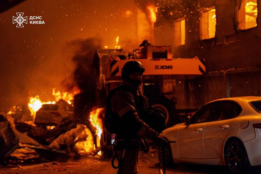 In this photo provided by the Ukrainian Emergency Service, emergency services personnel work to extinguish a fire following a Russian air attack in Kyiv, Ukraine, Wednesday, July 8, 2026. (Ukrainian Emergency Service via AP)