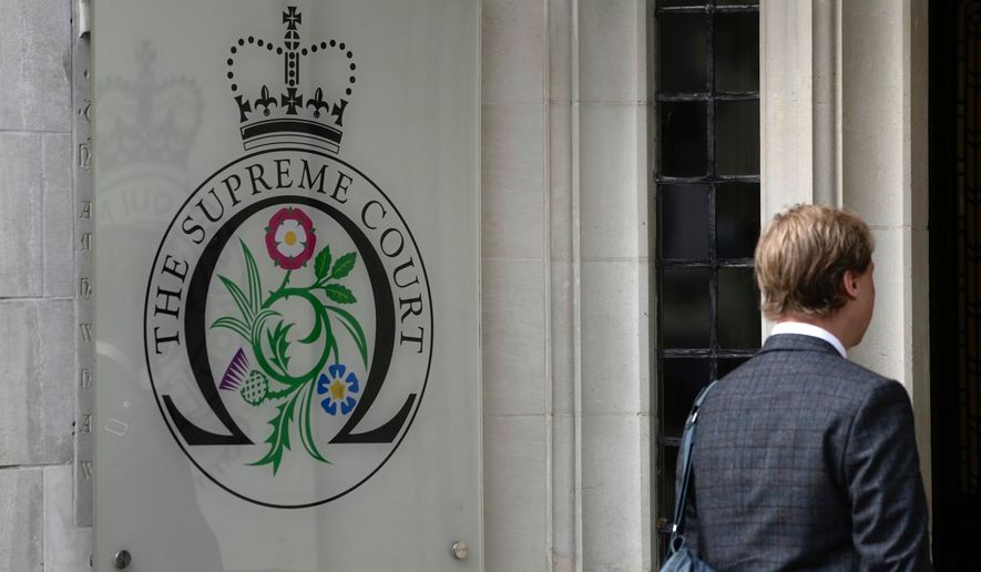 FILE - A man enters the Supreme Court in London, on Oct. 9, 2023. (AP Photo/Kin Cheung, File)